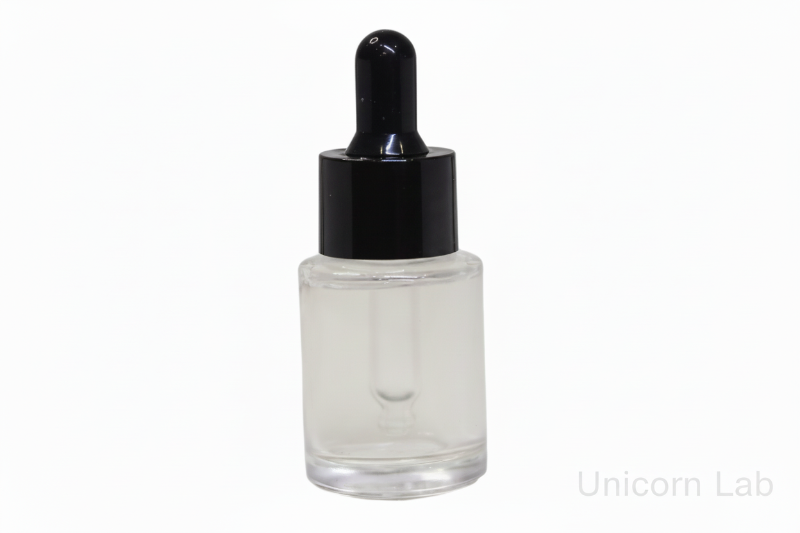 Clear 15ml glass flat shoulder dropper bottle with black cap on a white background