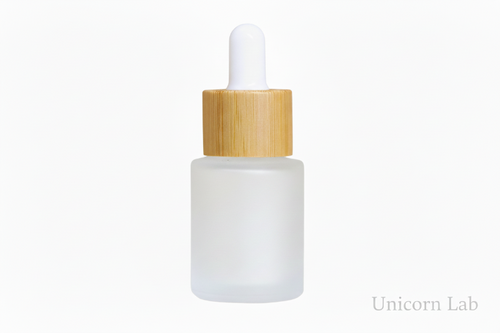 Frosted glass 15ml flat shoulder dropper bottle with wooden cap on a white background