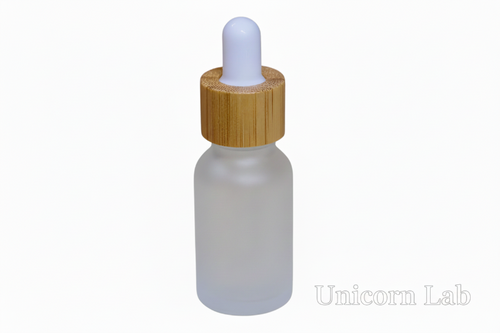 Frosted glass 15ml round dropper bottle with a wooden cap on a white background