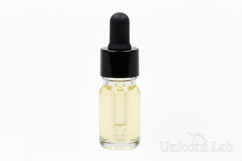 Clear 5ml round dropper bottle with black cap on white background with jojoba oil