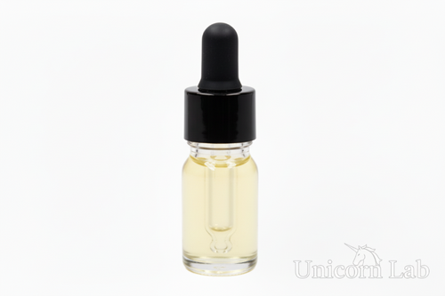 Clear 5ml round dropper bottle with black cap on white background with jojoba oil