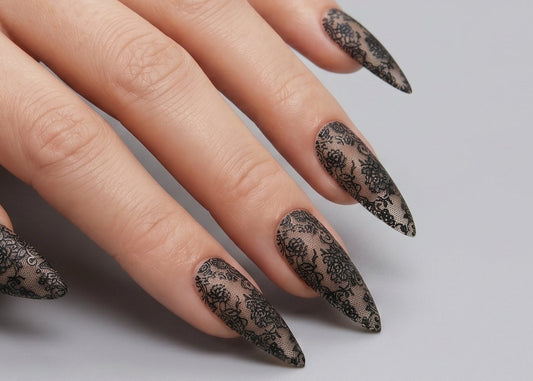 Hand with black and gold patterned nails on a gray background. Black Floral Lace Waterslide Decal