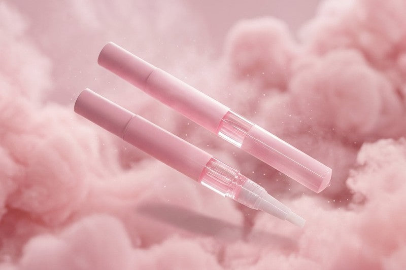 Two pink fairy floss scented 3ml cuticle oil pens on a soft pink background from Australian supplier Unicorn Lab 