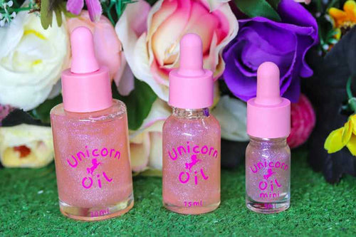 Floral Explosion Unicorn Cuticle Oil in 5ml, 15ml and luxury 30ml sized dropper bottles with pink lid. A colourful assortment of flowers is pictures behind the sparkly nail serums