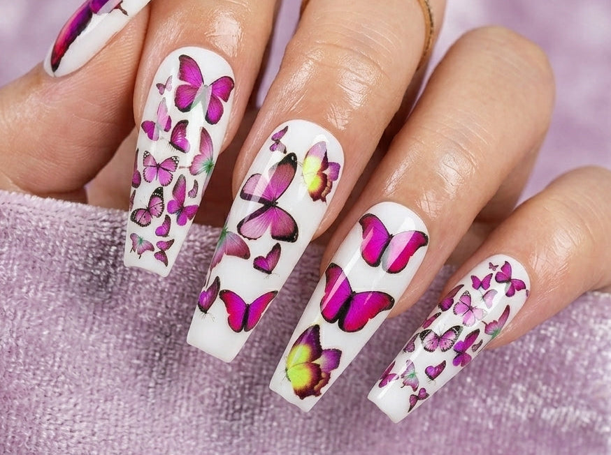 Nails with butterfly design on a pink background