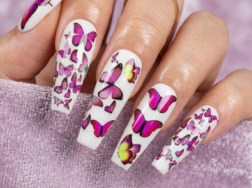 Nails with butterfly design on a pink background
