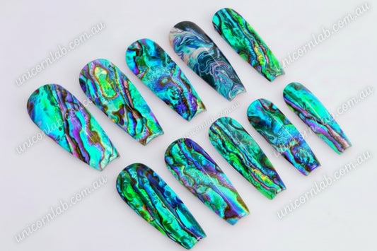 Ultra thin Abalone Waterslide Decal displayed on a set of coffin shaped nails - Unicorn Lab