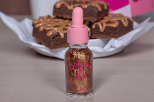 15ml glass dropper bottle of Chocolate Brownie Unicorn Cuticle Oil featuring golden shimmering oil and a professional label.