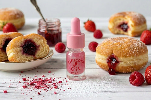 Jam donut scented cuticle oil, surrounded by raspberry jam donuts, Australian made cuticle oils.