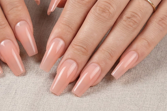 Close-up of hands with pink nail polish on a textured beige background