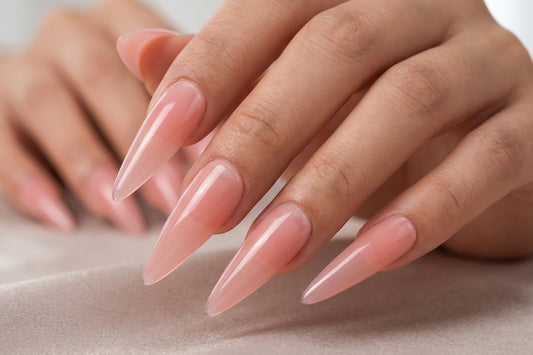 Close-up of hands with pink nail polish on a neutral background