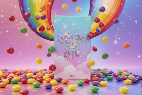 Skittles Unicorn nail serum in its 30ml box surrounded by colourful falling candy - Unicorn Lab