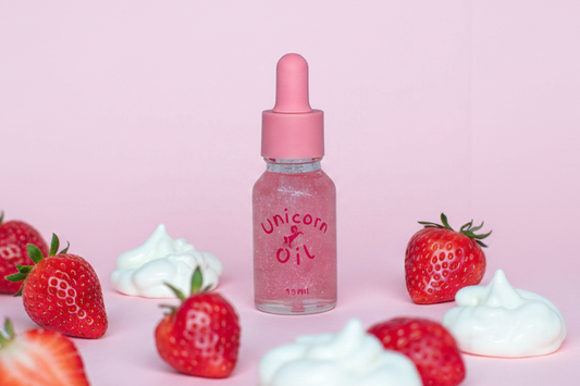 15ml glass dropper bottle of Strawberries & Cream Unicorn Cuticle Oil featuring pink shimmering oil and a professional boutique label.