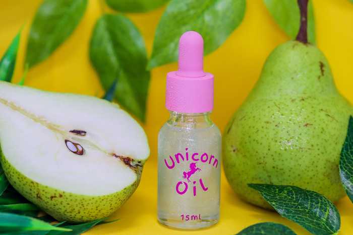 15ml dropper bottle of the luxury French Pear Unicorn Cuticle Oil serum for professional salons.