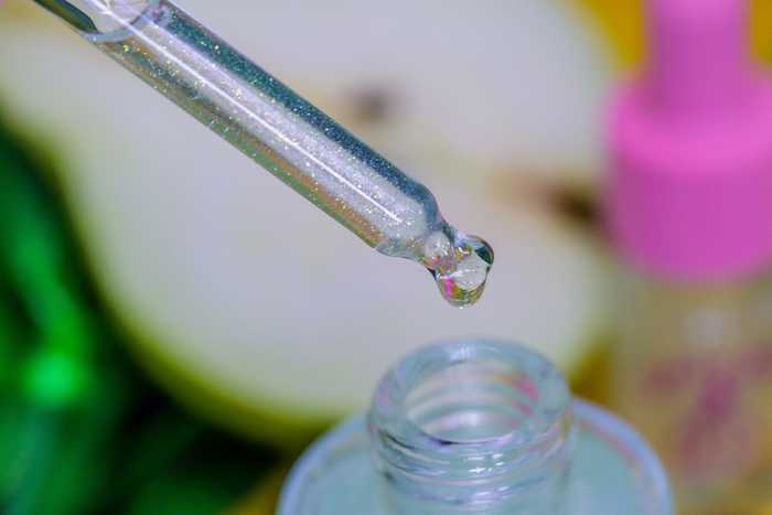French Pear Unicorn Cuticle Oil - marco shot of green sparkly cuticle oil