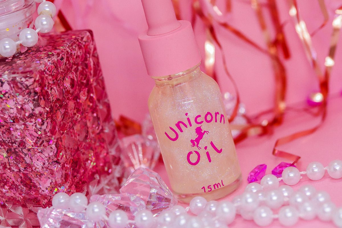 30ml glass bottle of Eternal Amour Unicorn Cuticle Oil displayed next to its magnetic luxury style gift box, showcasing a premium perfume-inspired nail serum.