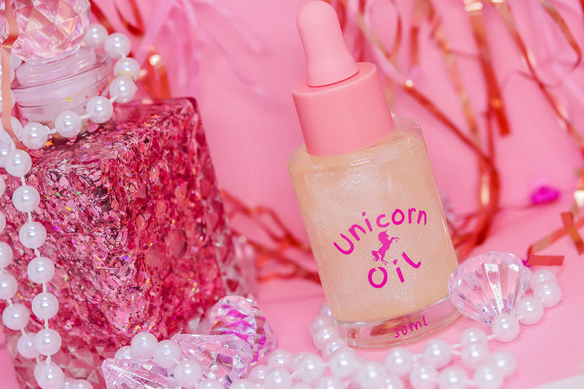 Eternal Amour Scented Unicorn Cuticle Oil - 30ml luxury nail serum in dropper bottle with pink cap pictured in a pink themed scene with pearls