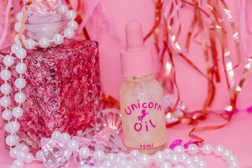 15ml glass bottle of Eternal Amour Unicorn Cuticle Oil displayed next to its magnetic luxury style gift box, showcasing a premium perfume-inspired nail serum.