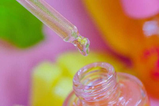 A detailed macro shot of Mango & Guava Unicorn Cuticle Oil - with shimmer oil dripping into bottle